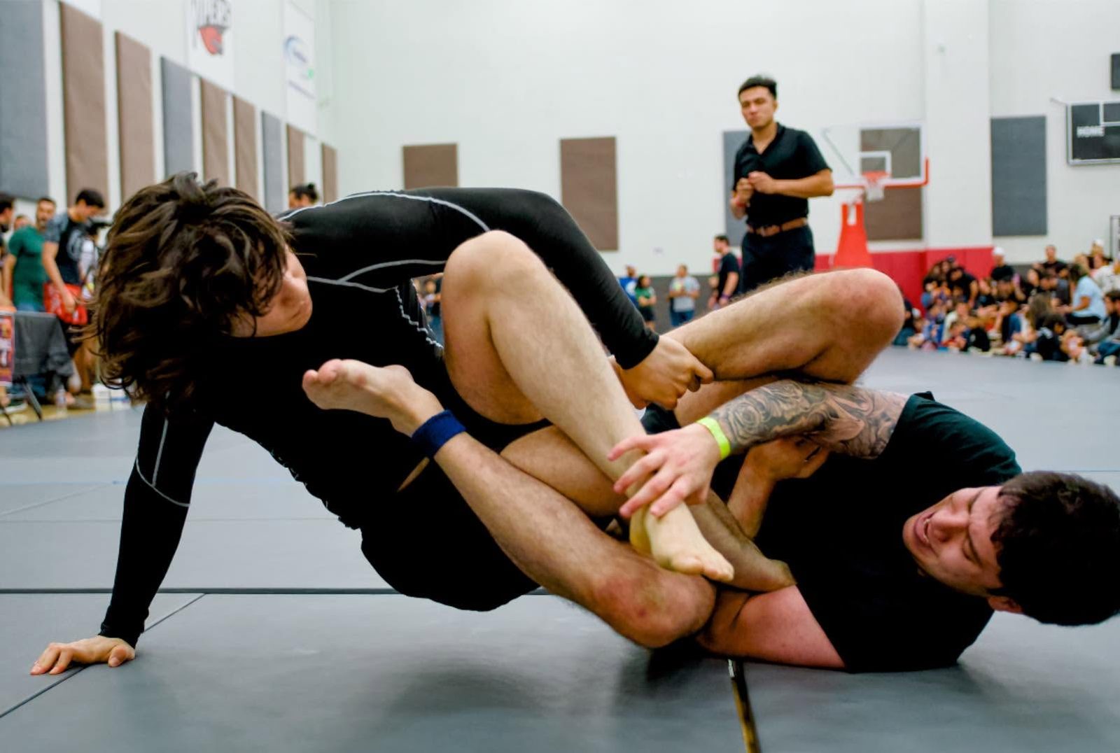 Two competitors grappling at a tournament