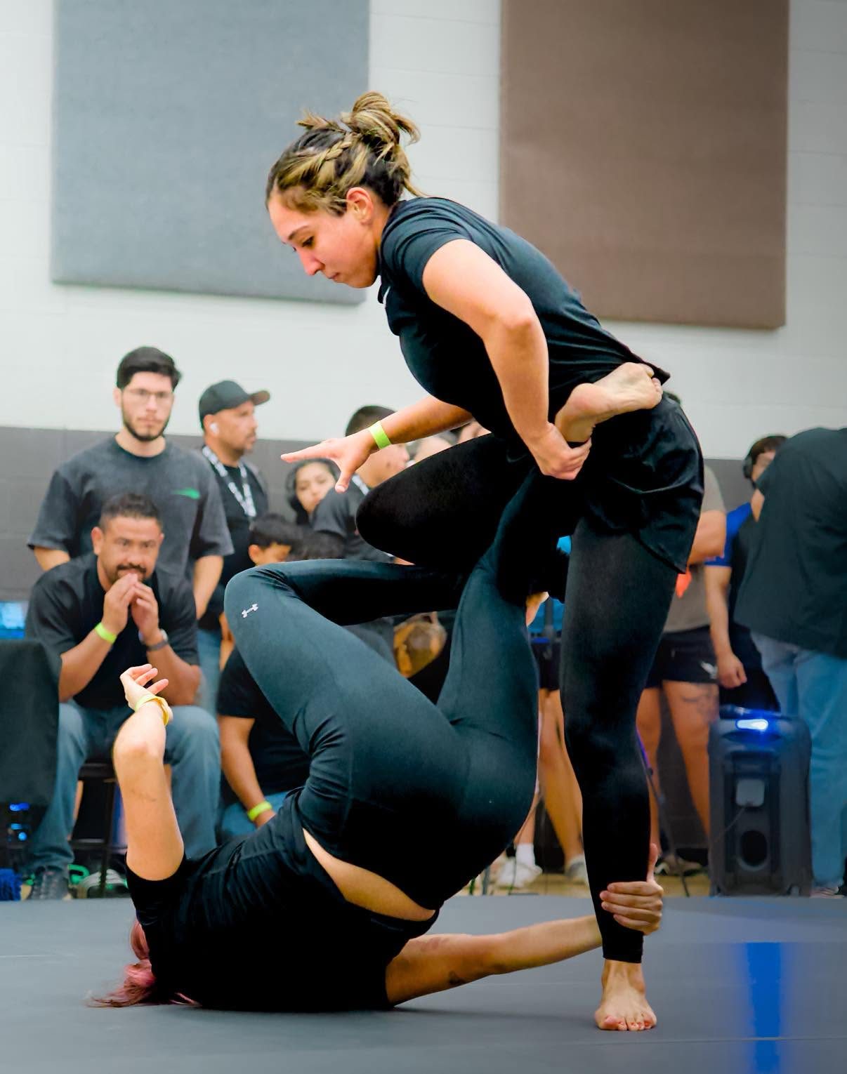 A competitor working to pass guard in competition